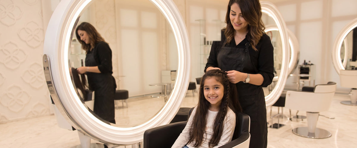 A girl having her hair braided at Kingdom of Beauty, Abu Dhabi