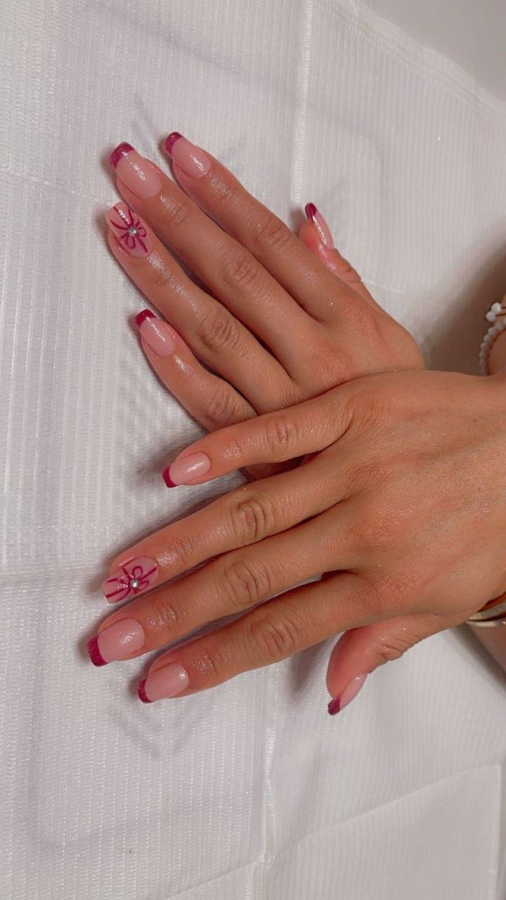 Pink French tips with bow nail art at Kingdom of Beauty, Abu Dhabi