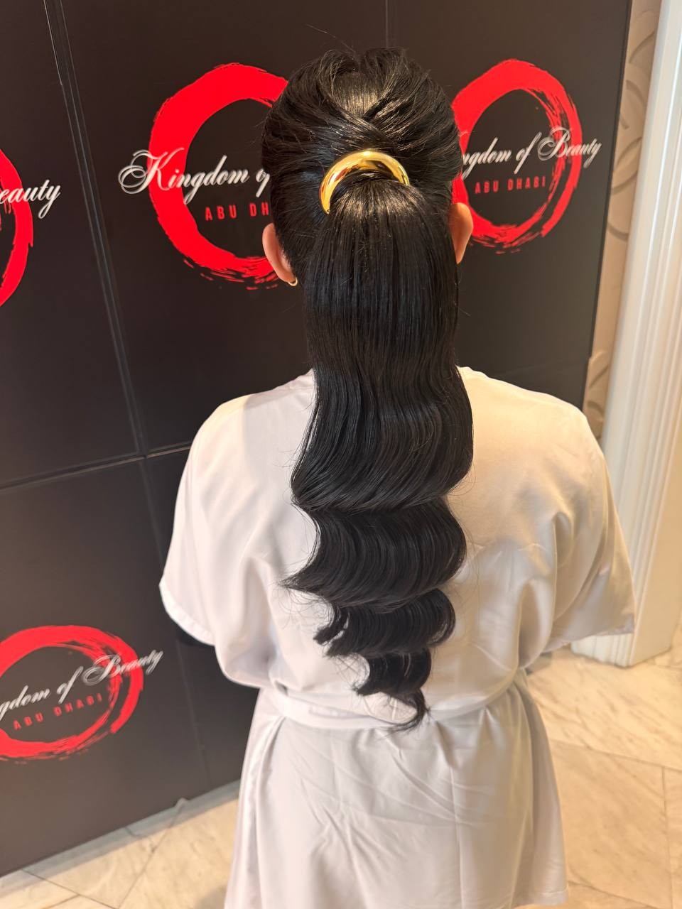 Sleek wavy ponytail with gold cuff by Kingdom of Beauty, Abu Dhabi
